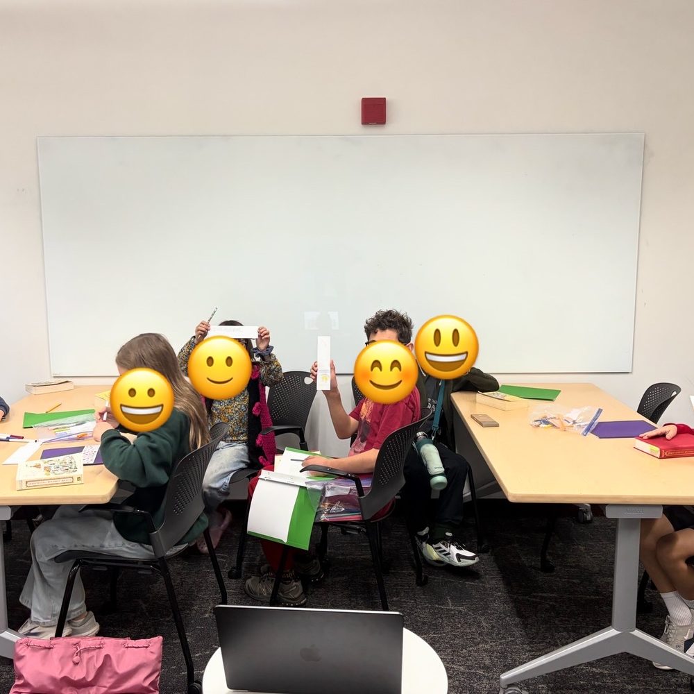Kids showing off the bookmarks they made at book club