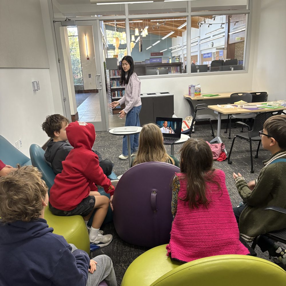 Kids relaxing together and watching a video during a book club session